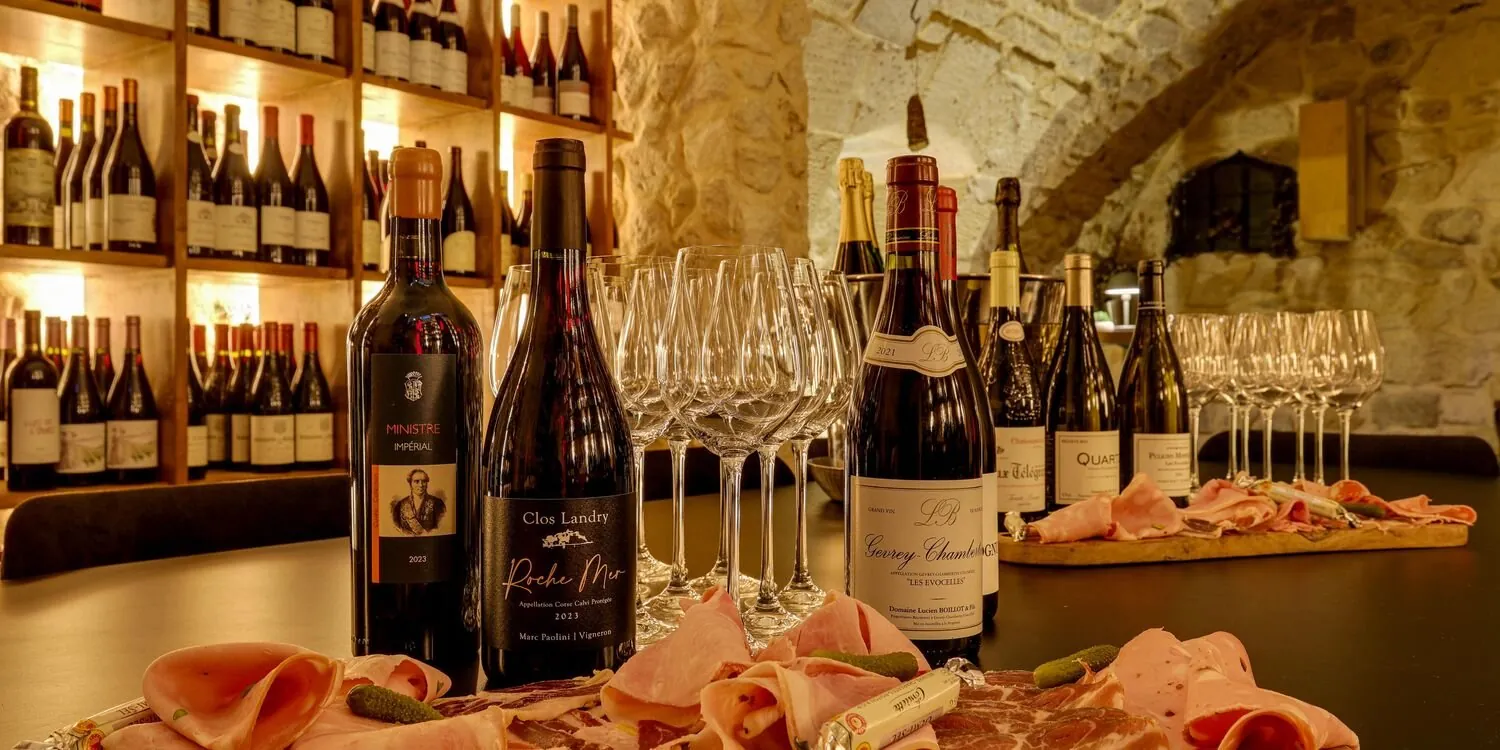 Bouteilles, verres et assiettes dans la cave